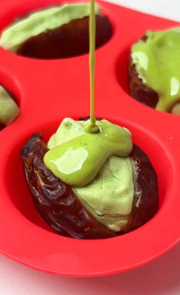 Medjool dates in a silicone mold filled with matcha cheesecake cream