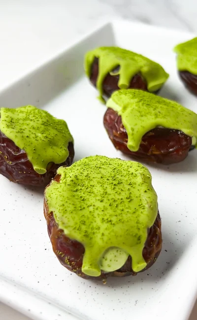 Matcha cheesecake stuffed dates with matcha white chocolate drizzle